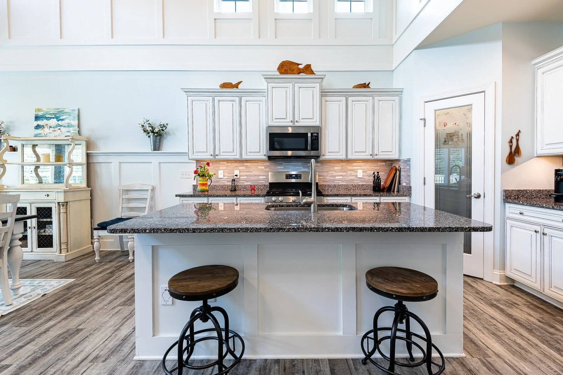 Kitchen island with seating and open dining area at 28839 W Henry Place.