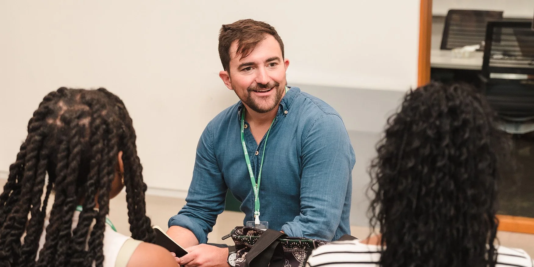CEO of COOP Careers, Kalani Leifer, sitting and chatting with two fellows