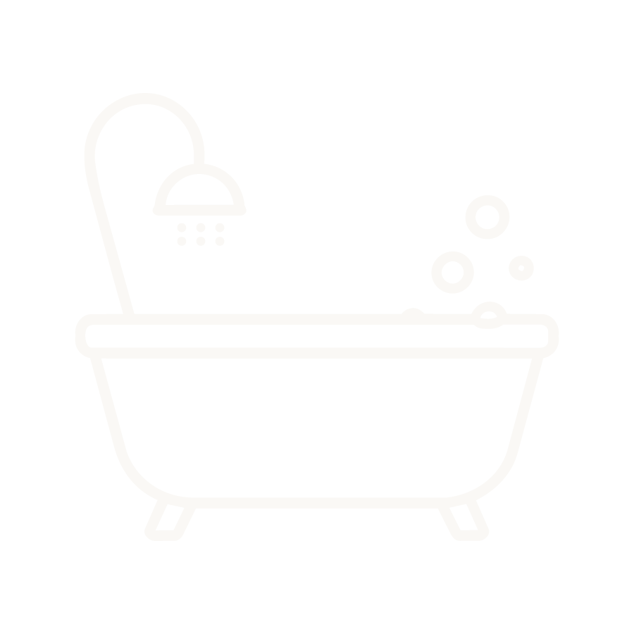 Icon of a bathtub with a showerhead and bubbles.