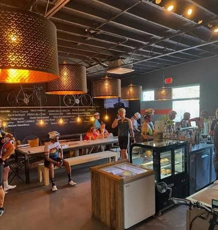 Internal photo of cyclists enjoying coffee at the cafe racer coffee shop