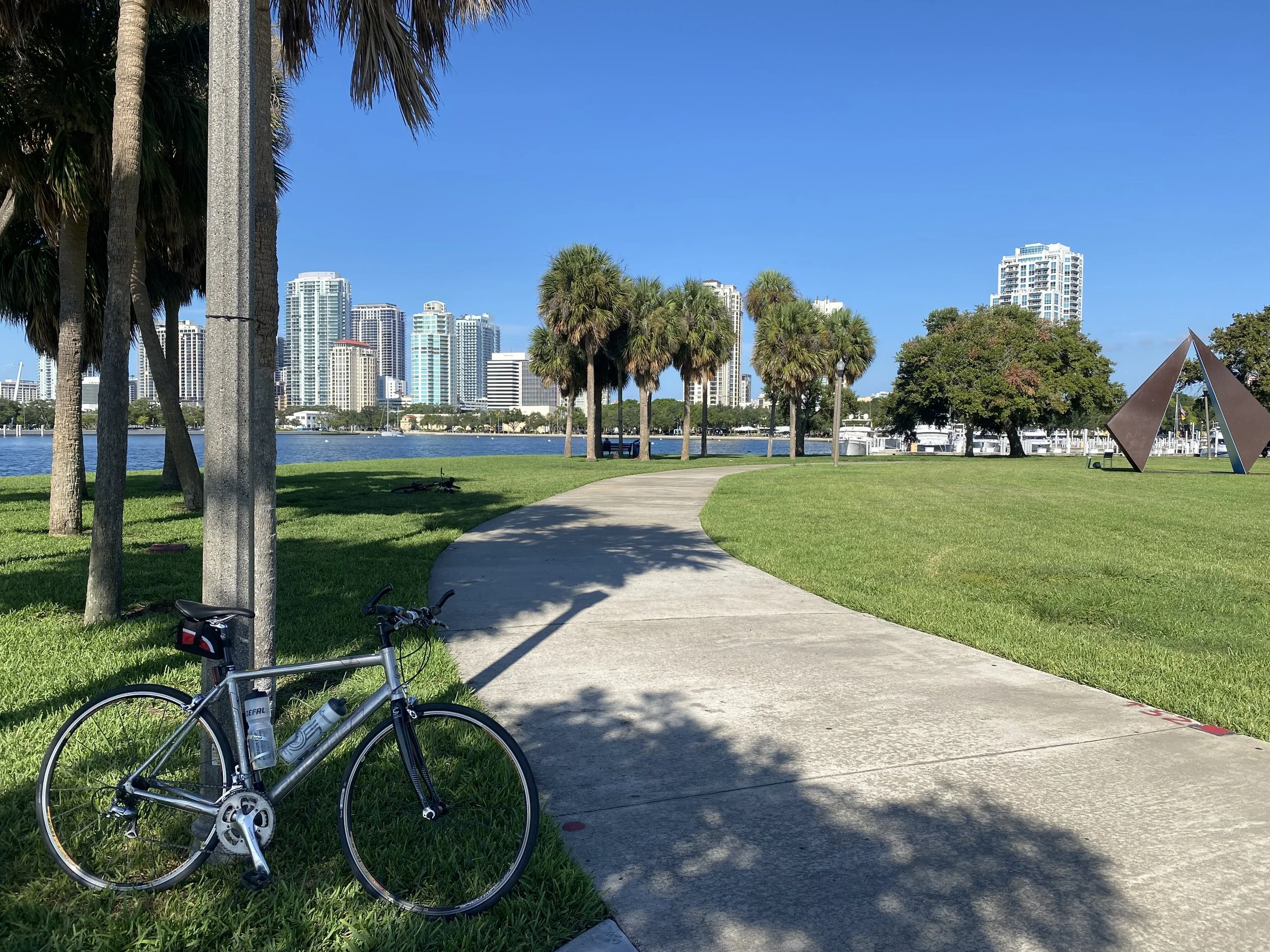 Bike in Vinoy Park with green parkland, ocean view and downtown St Pete in the background
