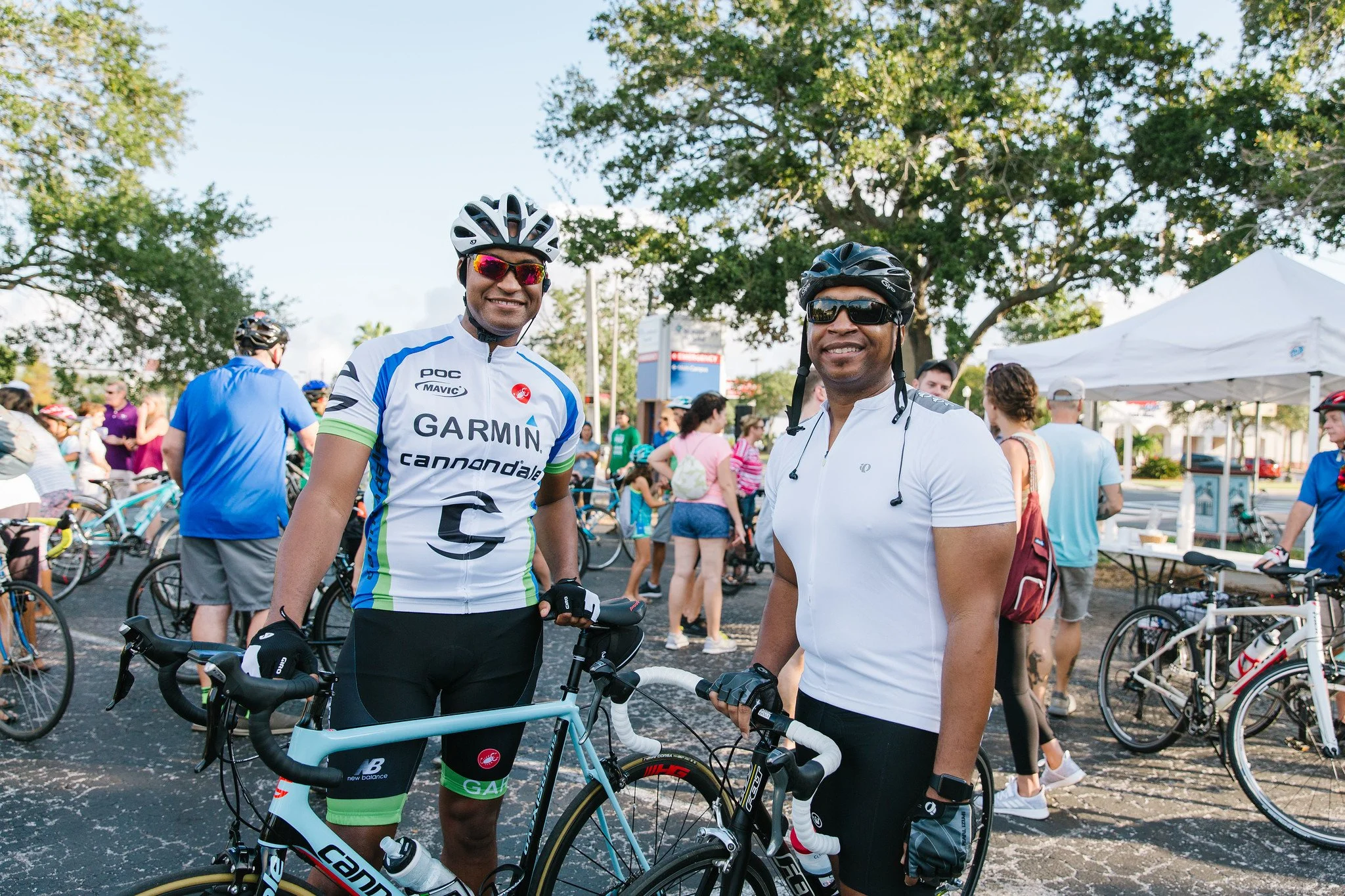 Friends out enjoying their florida cycling holday and stopping for refreshments. One has high quality cannondale road bike