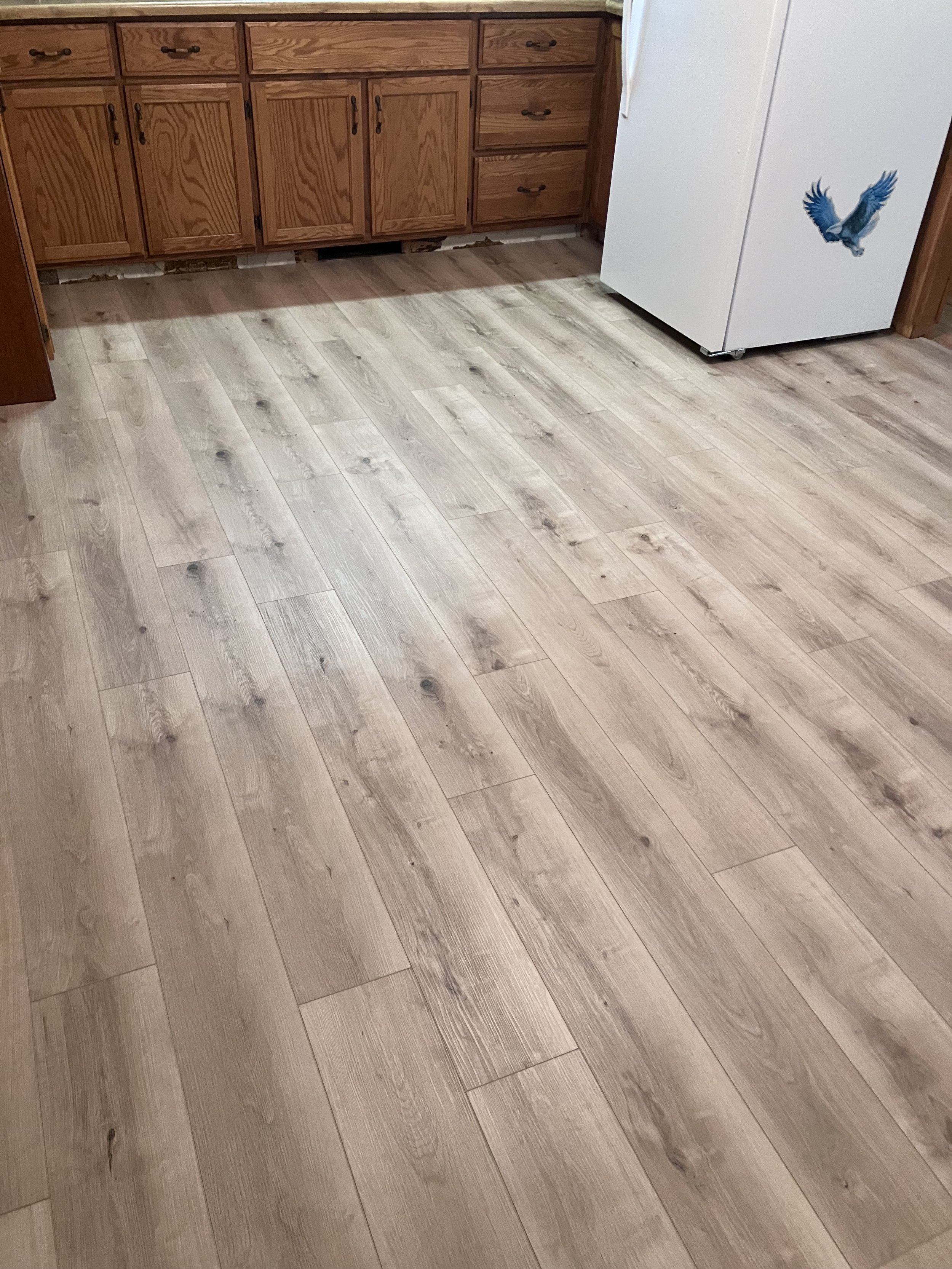 Kitchen floor after installation of Luxury Vinyl Plank (LVP) over Linoleum