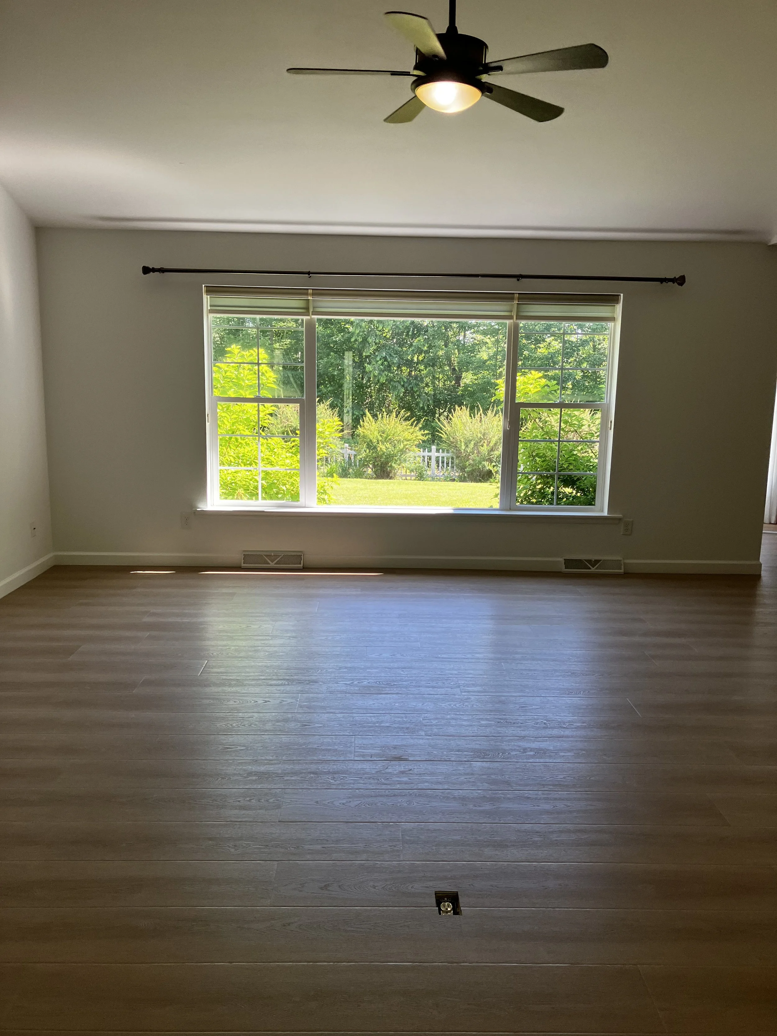 Living room after installation of dark-colored Luxury Vinyl Plank (LVP) flooring