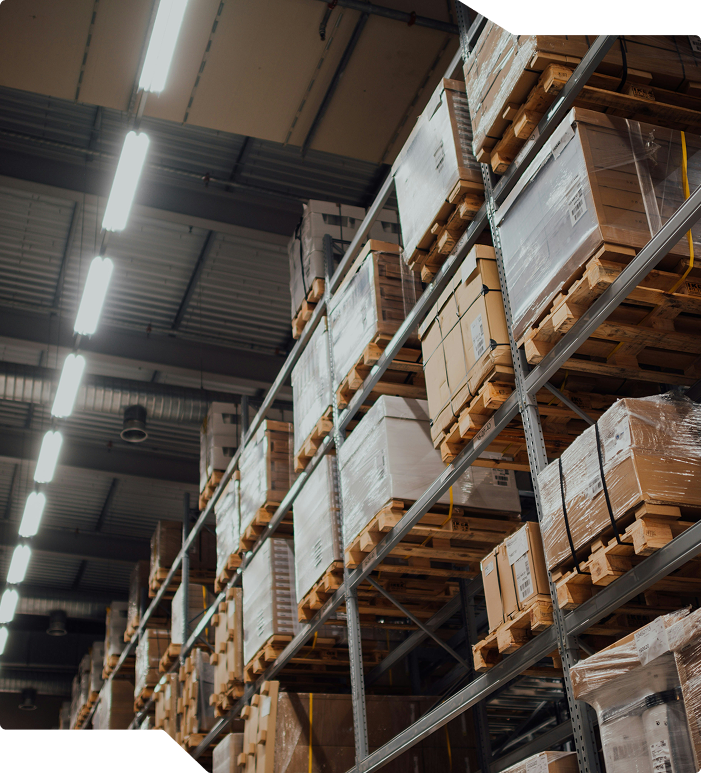 Warehouse interior with stocked storage racks.