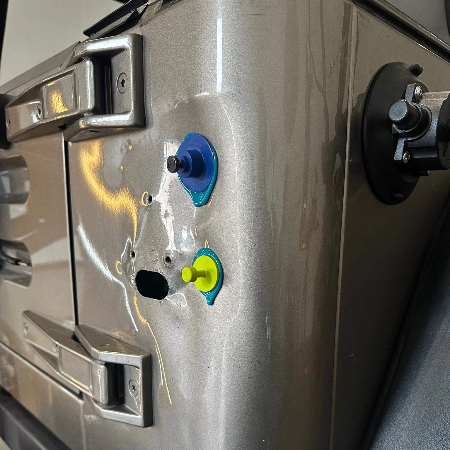 Minor collision dent on truck vehicle bujmper highlighted with paintless dent repair lighting