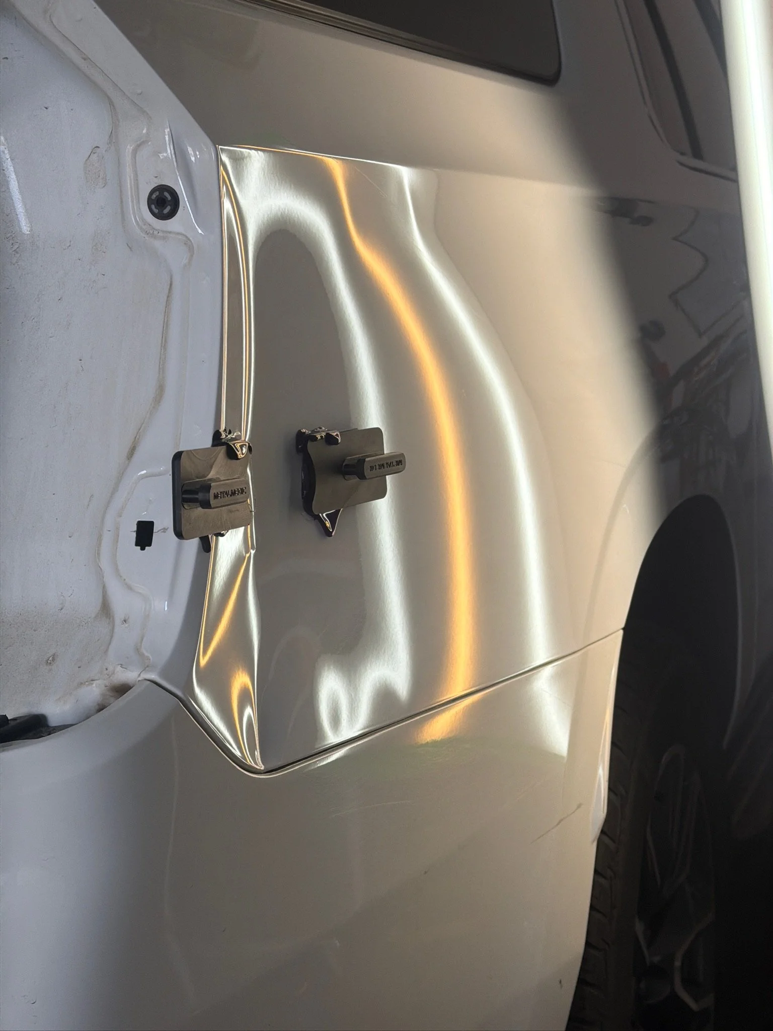 Body panel dent after a low-speed collision before PDR repair