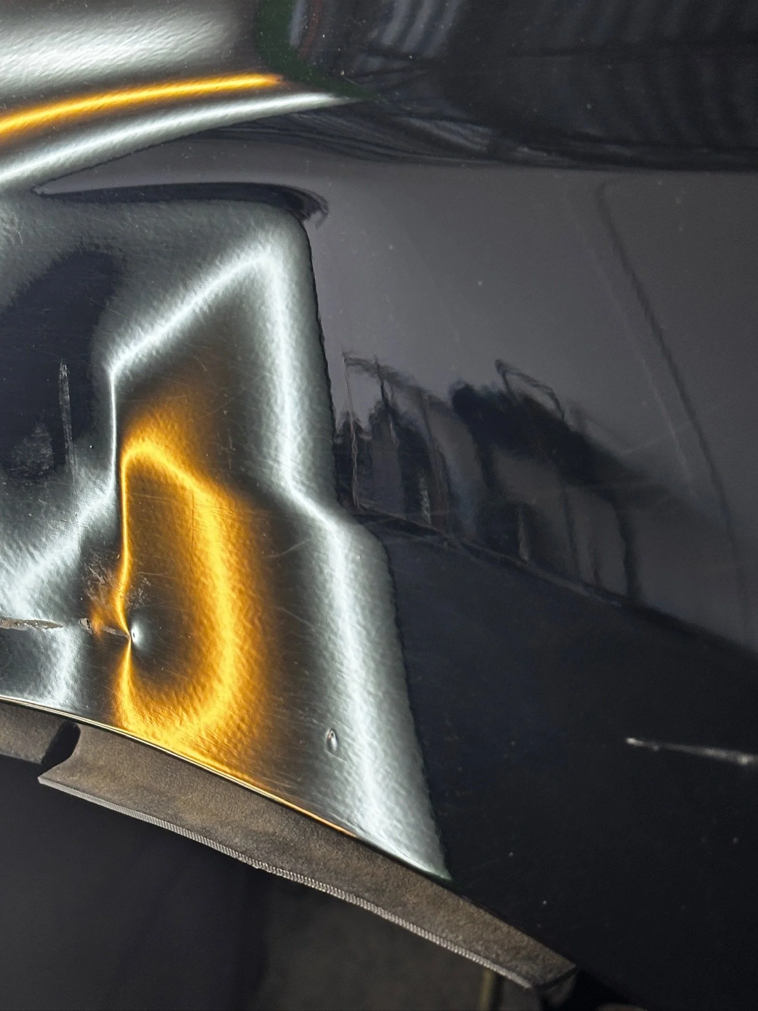 Close-up of a computer graphics card with gold accents and black plastic components.