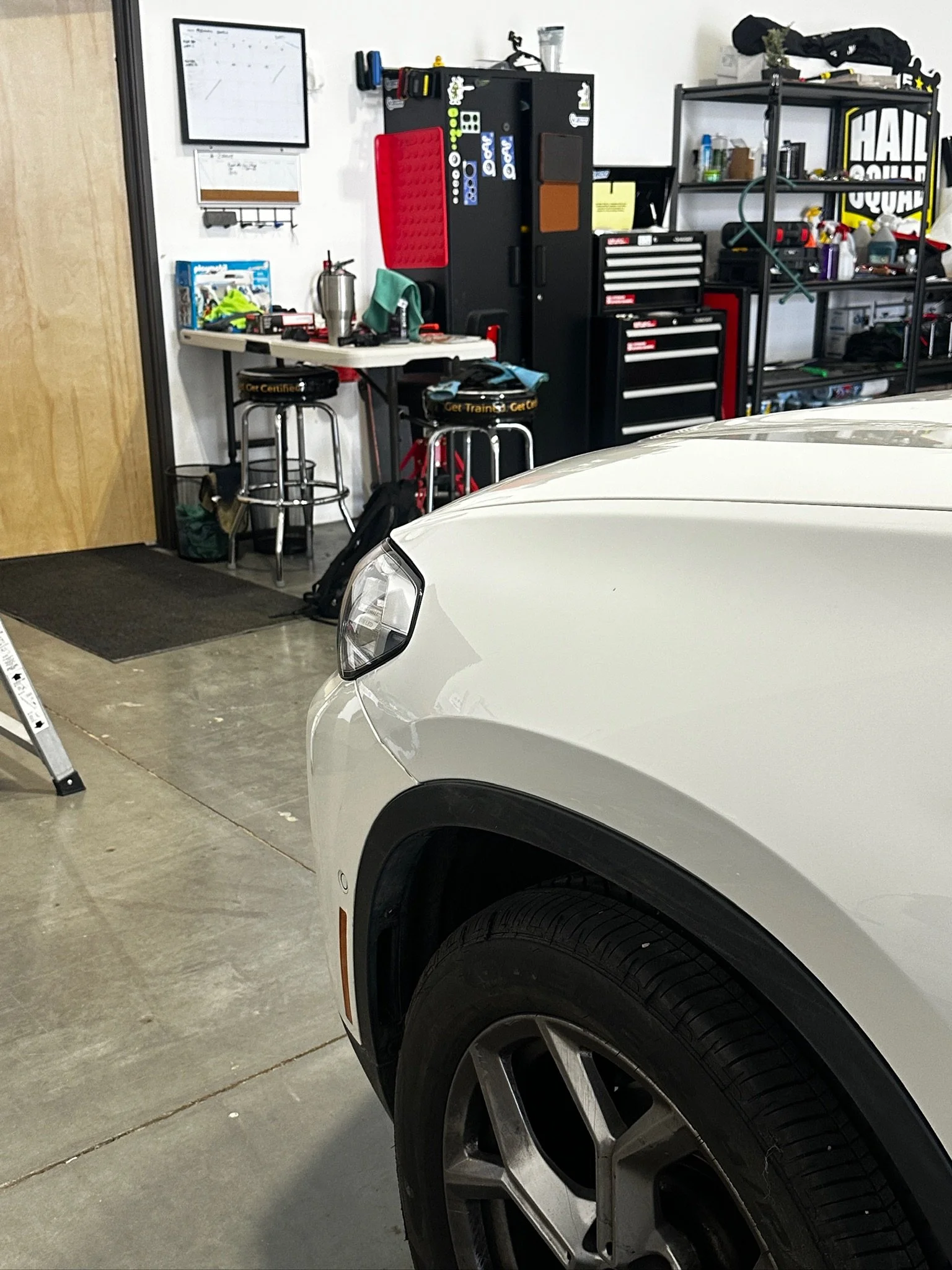 Minor crease damage being evaluated for paintless dent repair