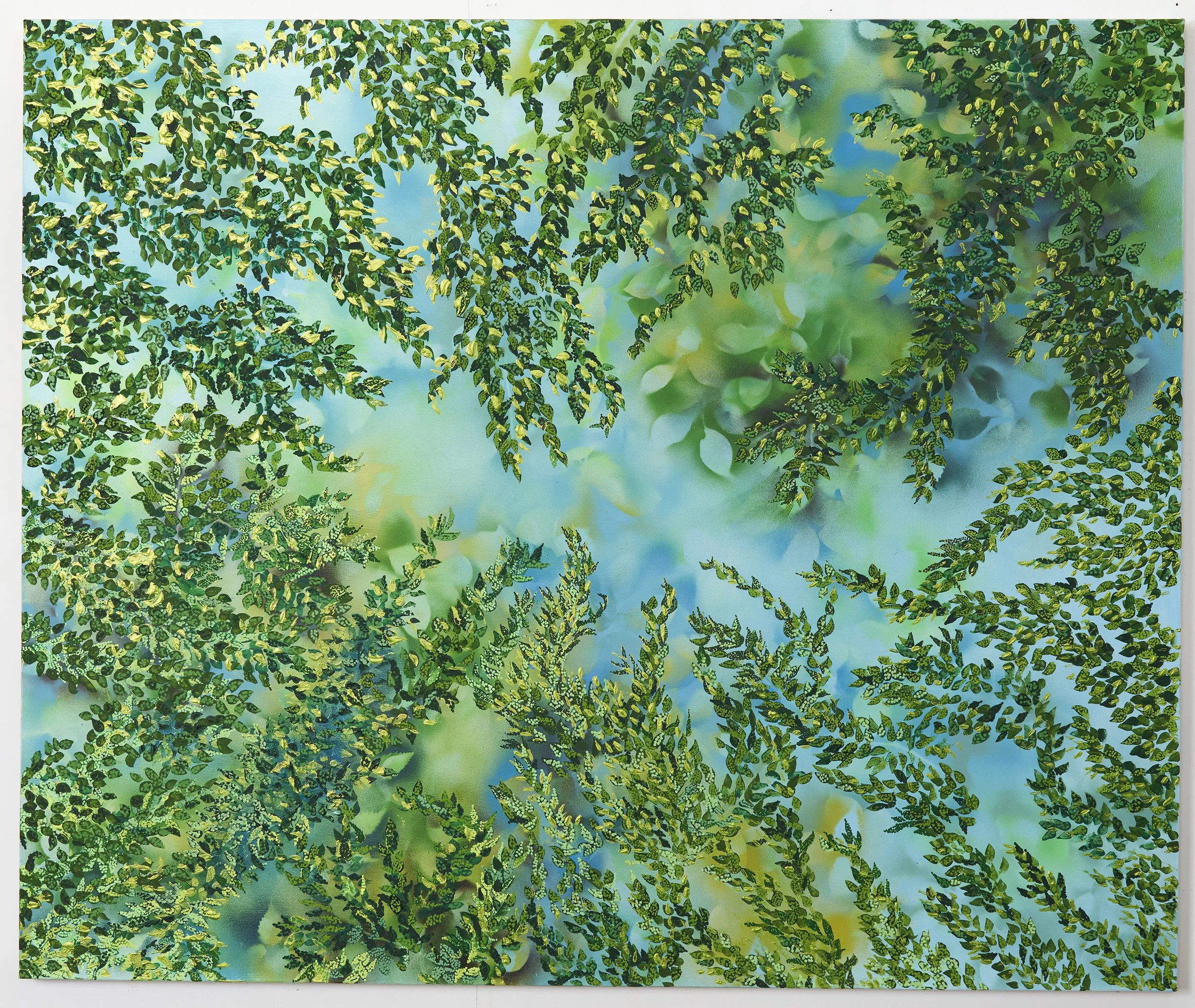 Close-up of hanging green ivy leaves against a blurred background of blue sky and clouds.