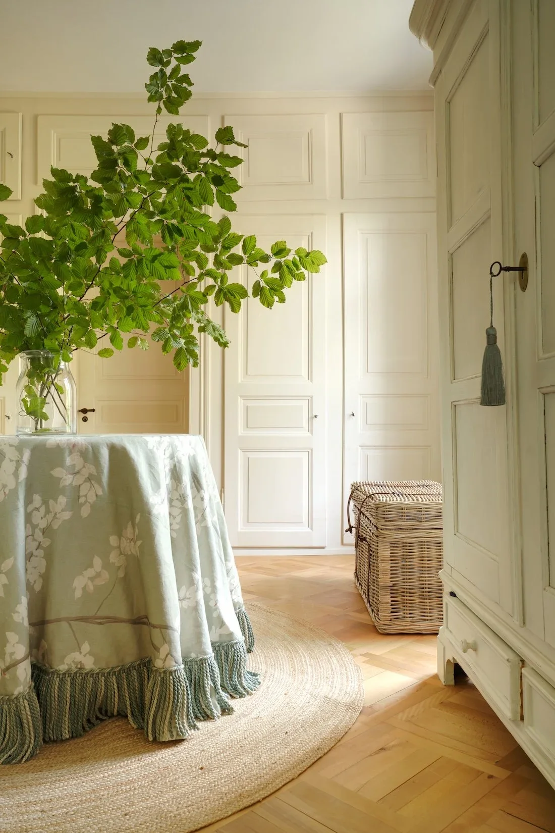 Round skirted table in Lewis & Wood Beech fabric in Jade, finished with a green Colefax & Fowler bullion fringe