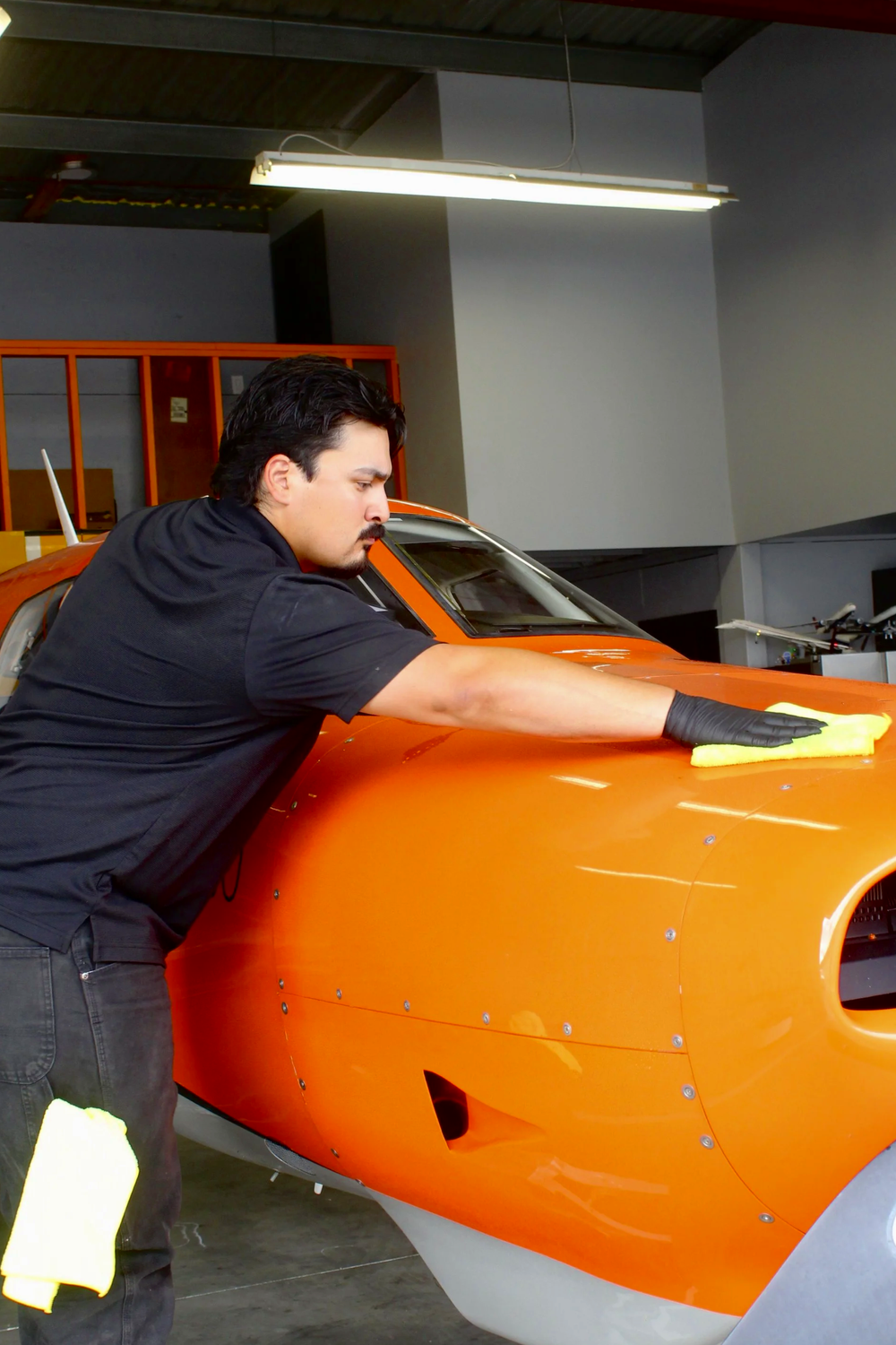 Maxwell Ramirez performing a dry wash on a Piper M350 at Long Beach Airport