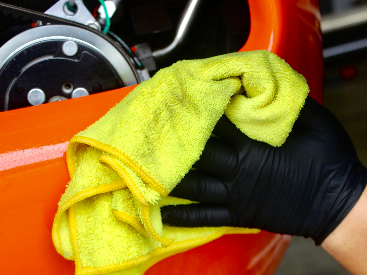 Technician wiping down a PA-46 with microfiber during an aircraft dry wash and degrease
