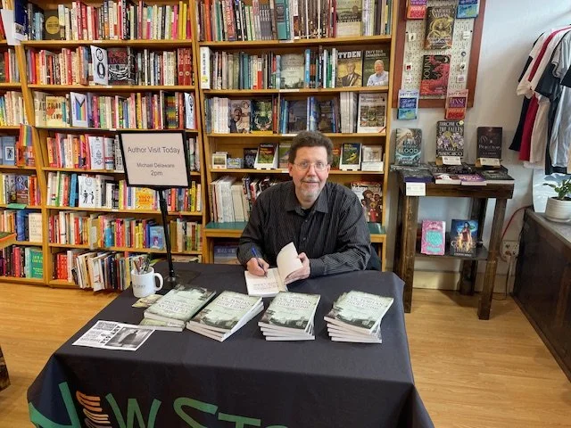 Author Michael Delaware signing books at a Michigan bookstore.