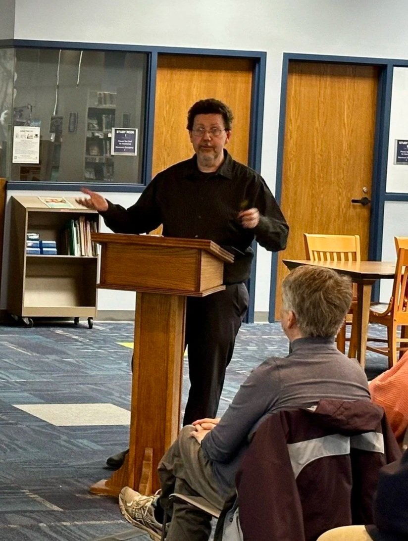 Michael Delaware presenting history stories from his book on Victorian Michigan True Crime at a library.