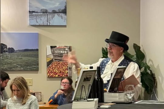 Author Michael Delaware presenting stories at a winery in Kalamazoo as part of a 'true crime and wine' program.