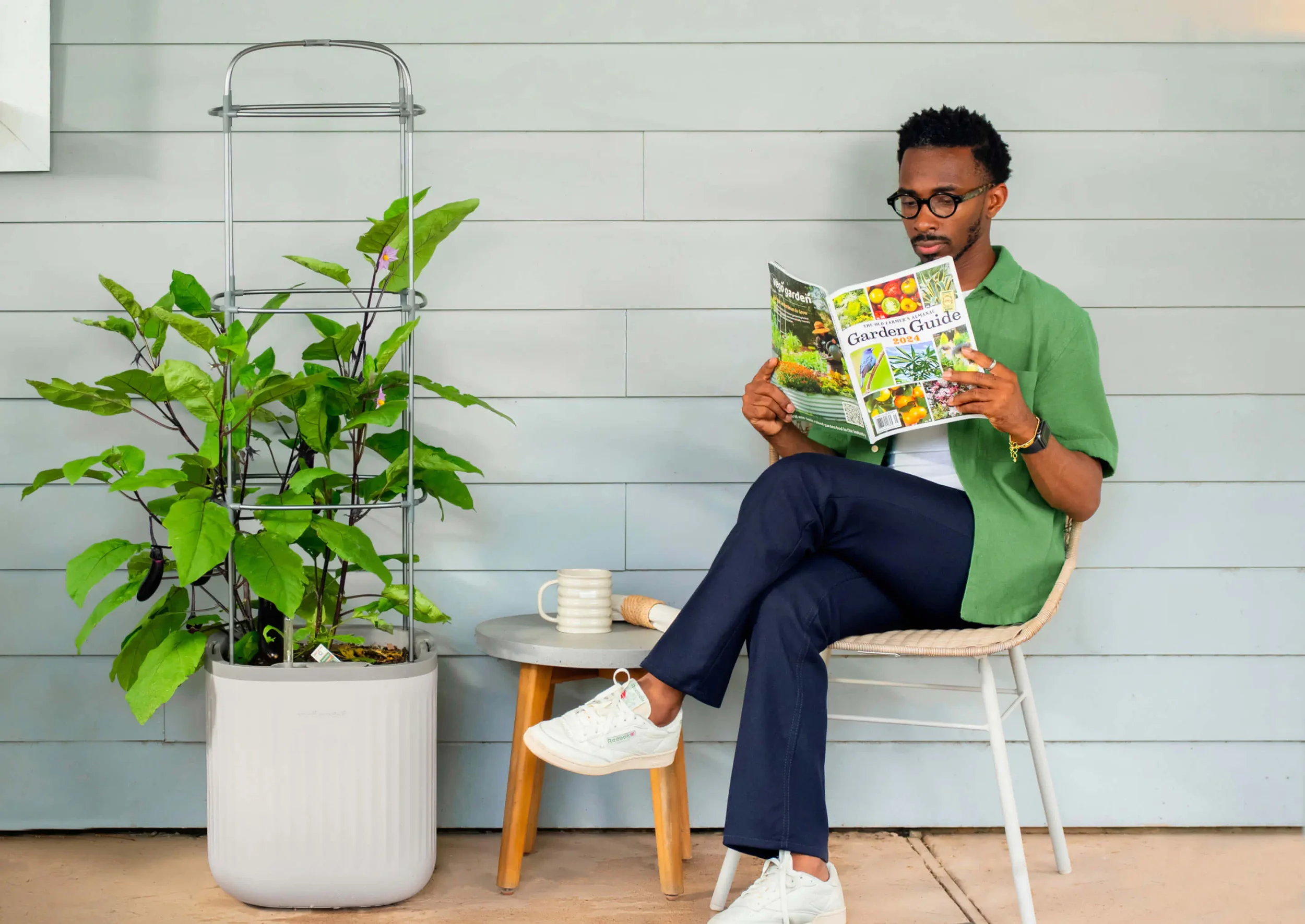 Vego Garden lifestyle photography: reading Garden Guide beside a planter