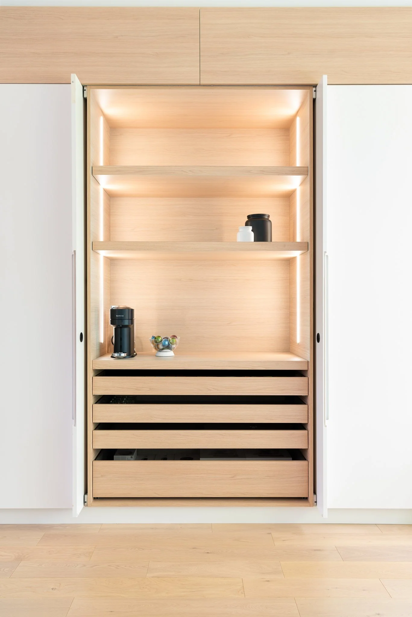 Backlit oak display cabinet with concealed storage at Beach House.