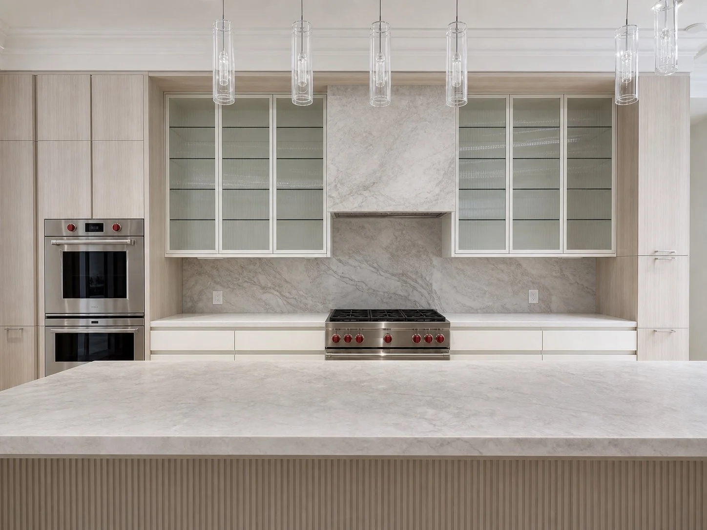Architectural visualization centred on the Forest Hill kitchen's quartzite hood, symmetrical reeded-glass cabinets, and handleless base cabinetry.