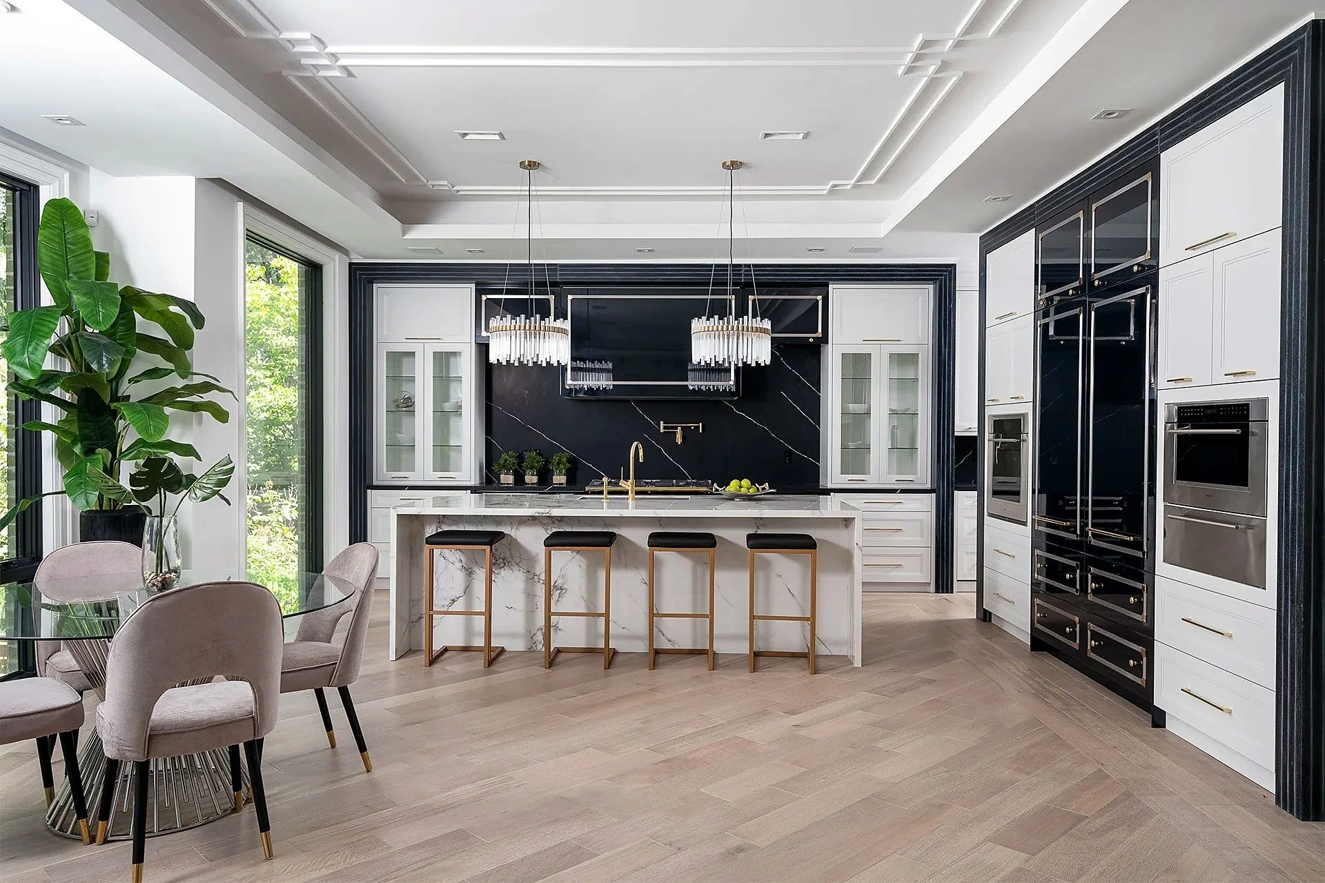 Black-and-white Hillhurst Parisian kitchen with brass detailing and a stone-wrapped island.