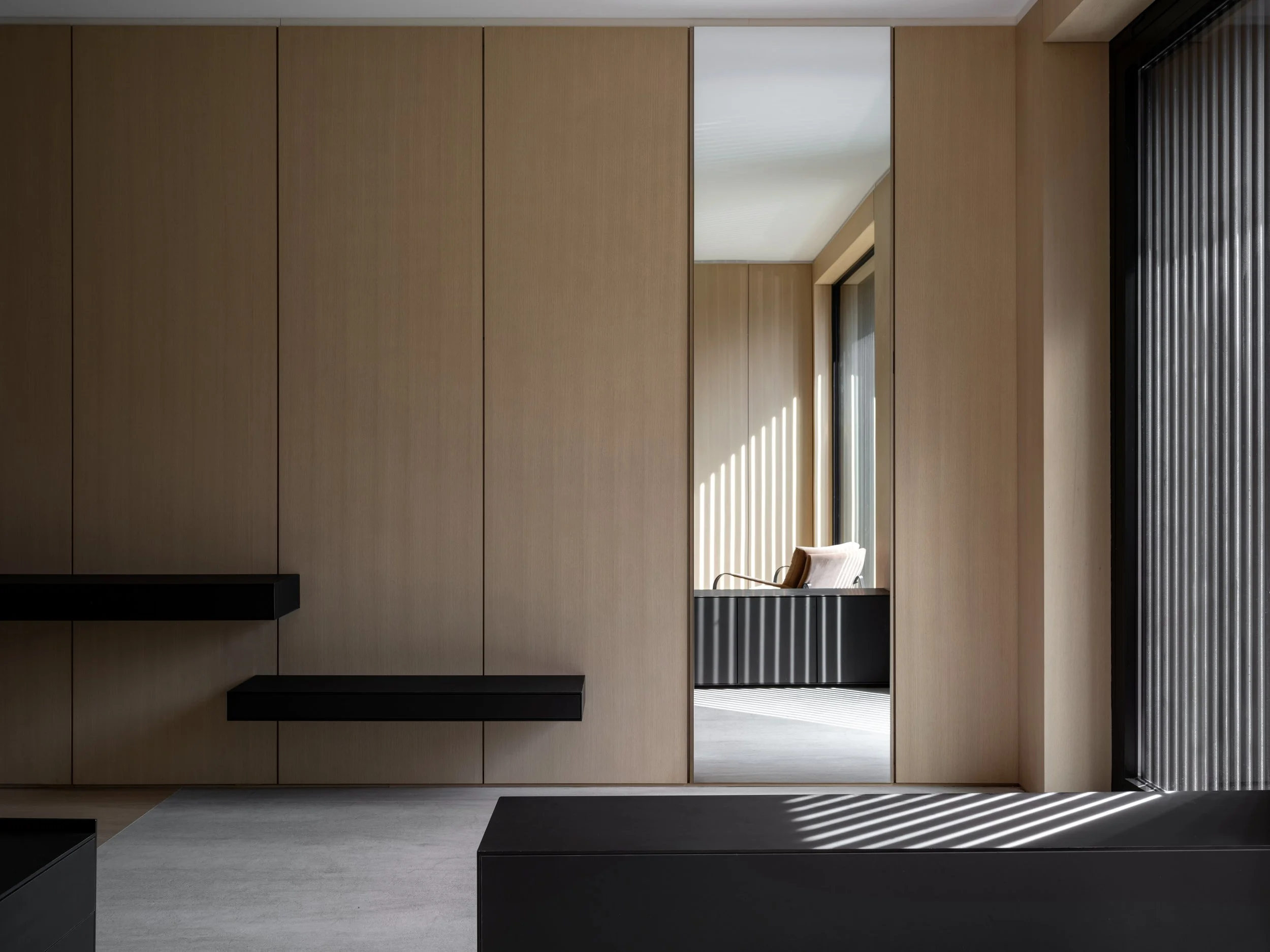 Precisely aligned oak wall panelling, floating drawers, and reeded glass at Montclair.