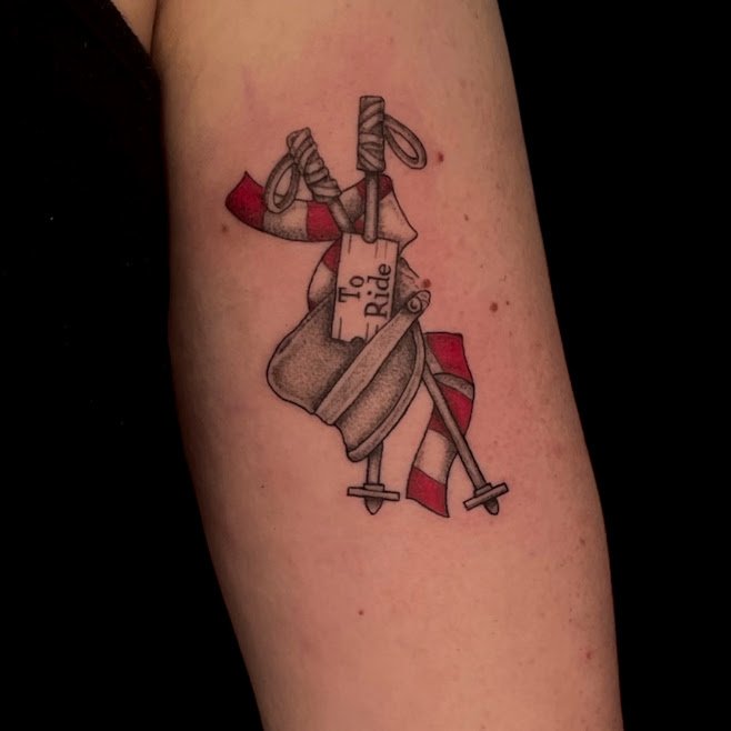 Tattoo of a toilet with a red and white striped towel and a hobby horse attached, featuring a tag that says 'To Ride'.