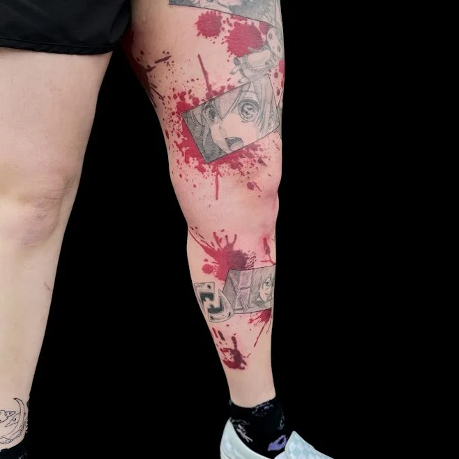 Tattoo of manga-style comic panels with red paint splatters on a person's leg.