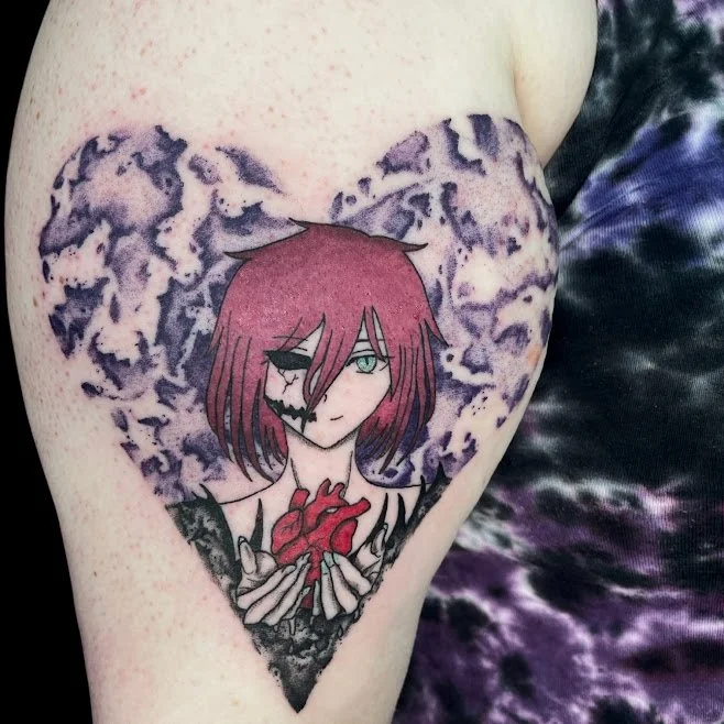 Tattoo of an anime-style character with red hair and a half skeleton face, holding a red heart. The background features purple and black abstract patterns.