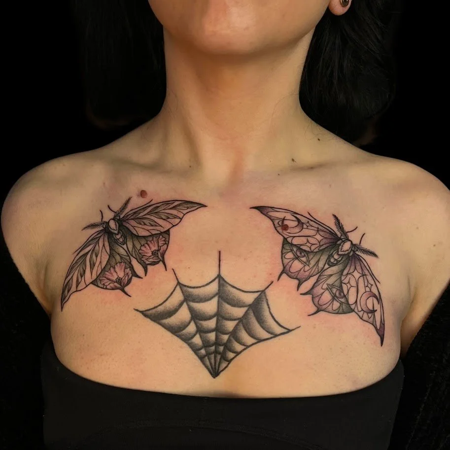 Tattoo of two butterflies and a spider web on a woman's collarbone