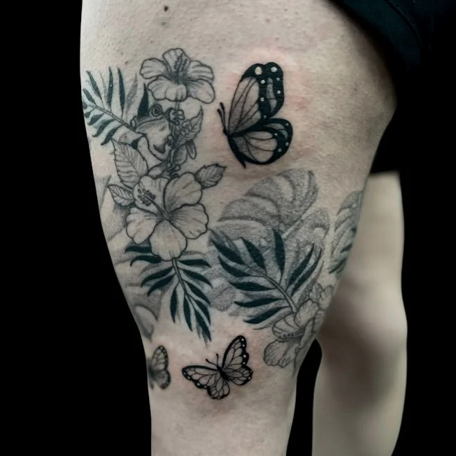 Black and gray floral tattoo with butterflies on thigh