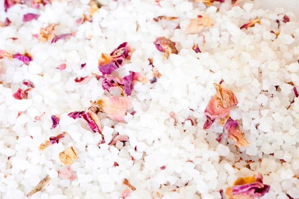 Close-up of epsom salt with dried flower petals mixed in.