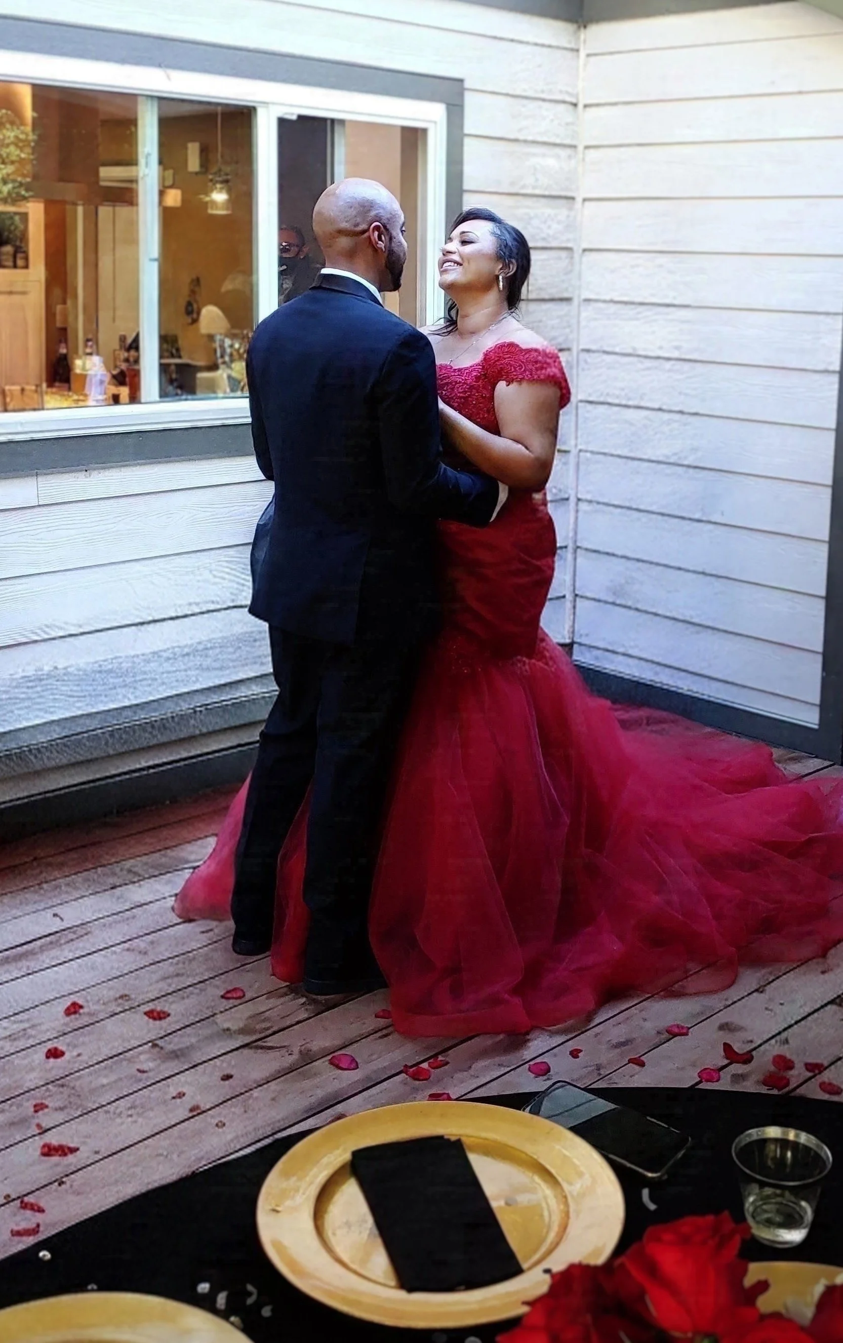 Image of bride and groom. bride in red dress.
