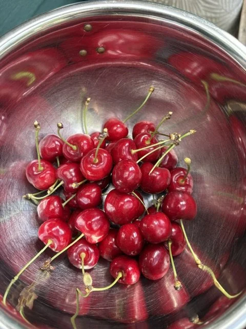 red cherries in a silver bowl