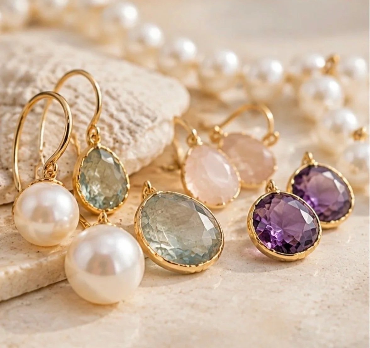 Pearl earrings and colourful gemstone jewellery featuring aquamarine, rose quartz and amethyst stones in delicate gold settings.