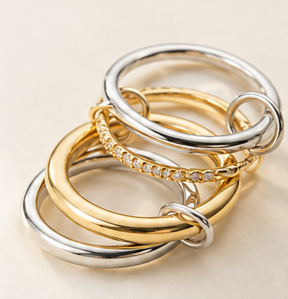 Contemporary stack of mixed gold and silver rings combining different   shapes, textures and metal finishes.\