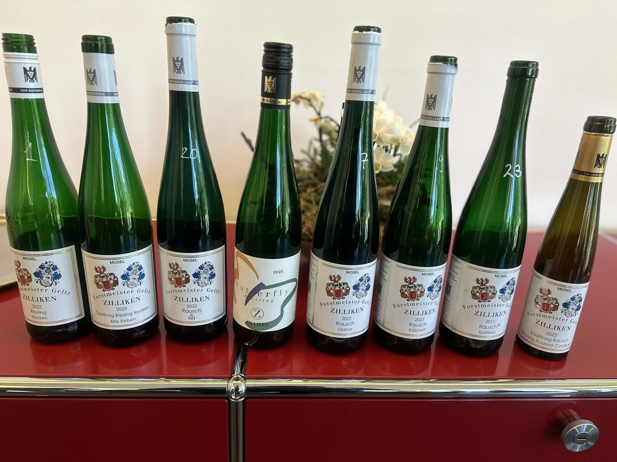 A flight of Riesling bottles lined up and numbered for a guided tasting