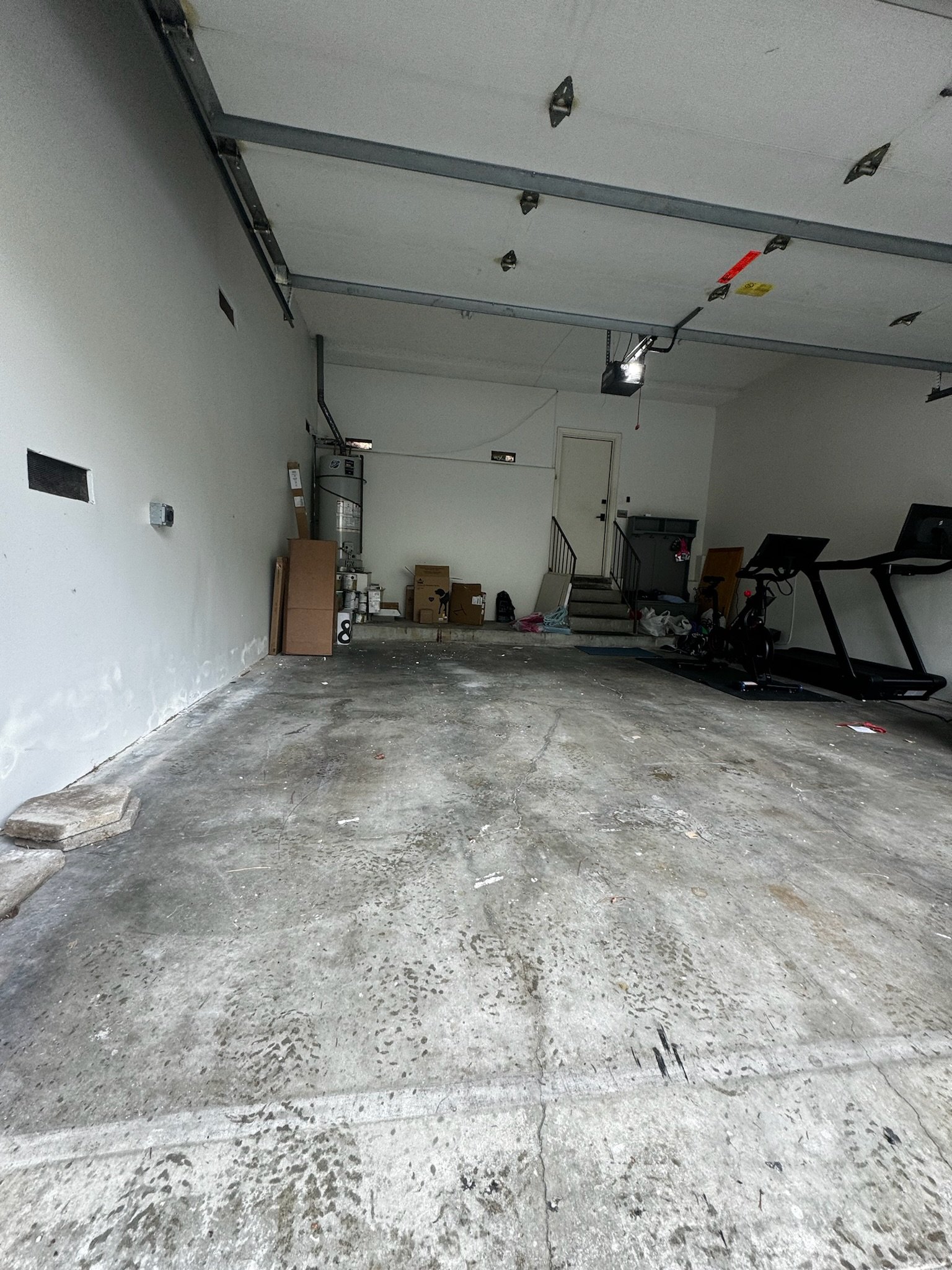 After photo of a completed garage cleanout in Winter Park, FL with all cardboard, packing materials, and junk removed by Coastal Cleanup & Hauling.