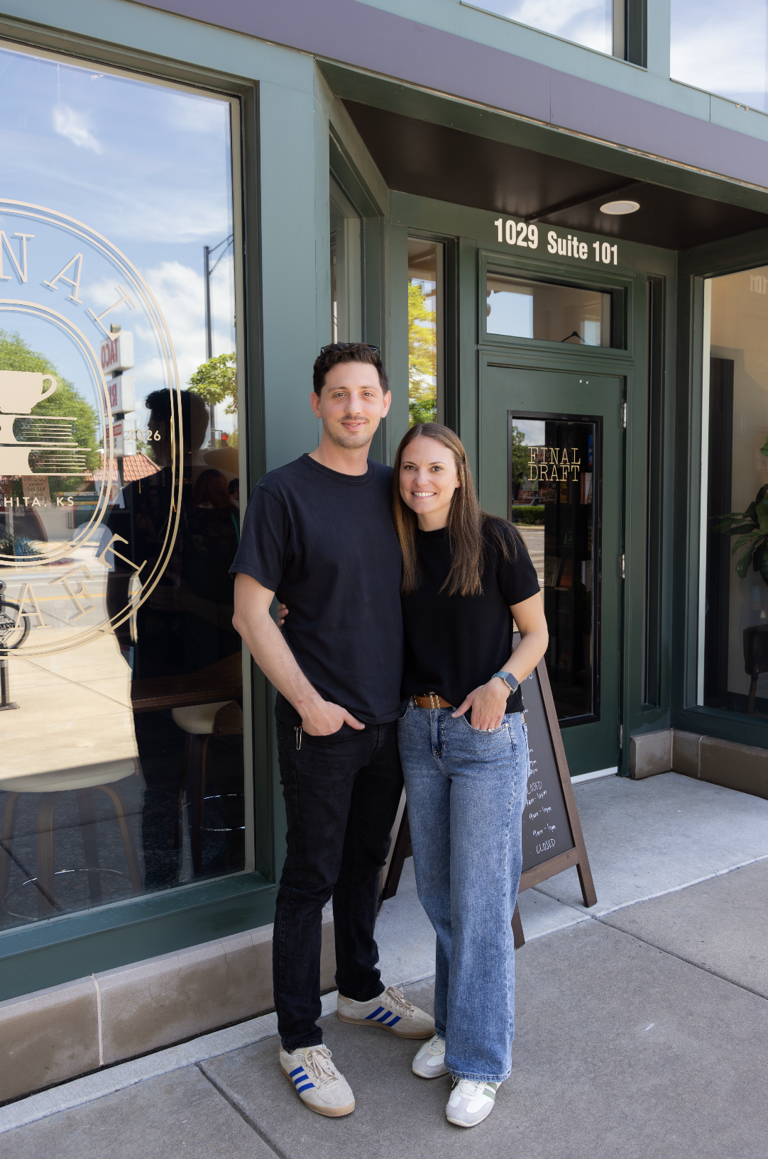 Natalie and Josh, owners of Final Draft standing in front of building front