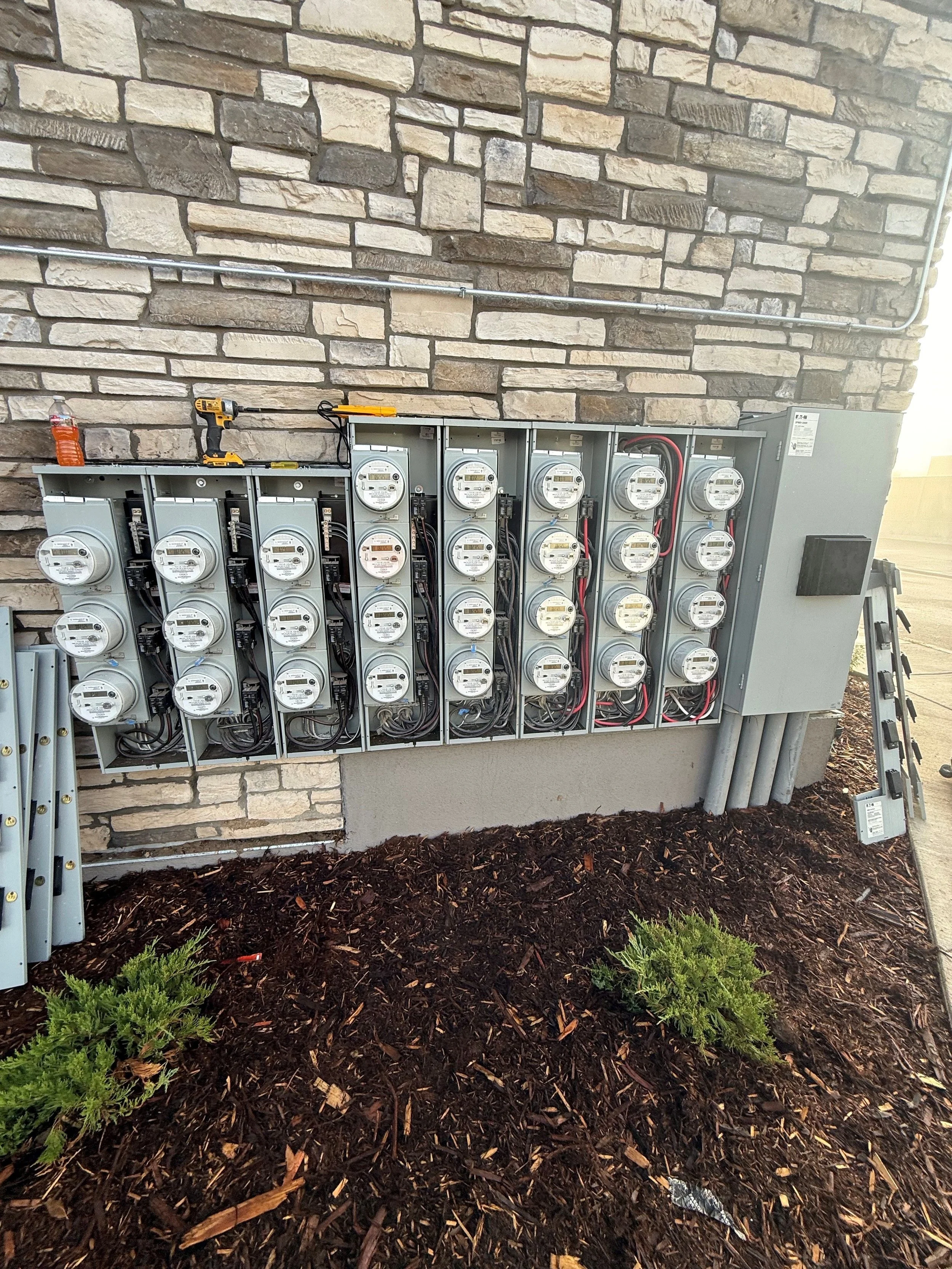Outdoor electrical meter installation with multiple meters and electrical wiring