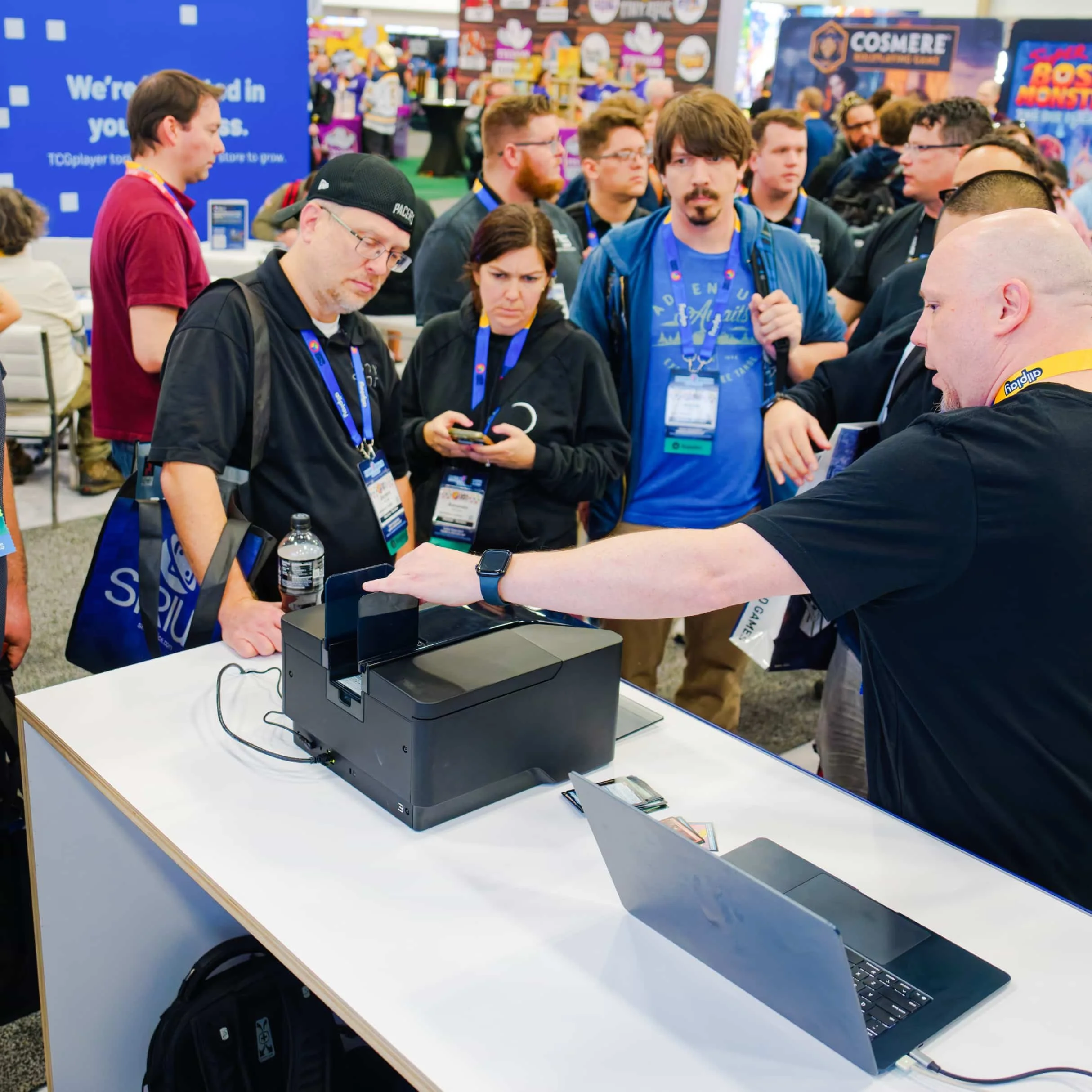 Trade show attendees watching a live demonstration of the Roca Sifter at the TCGplayer booth during GAMA.