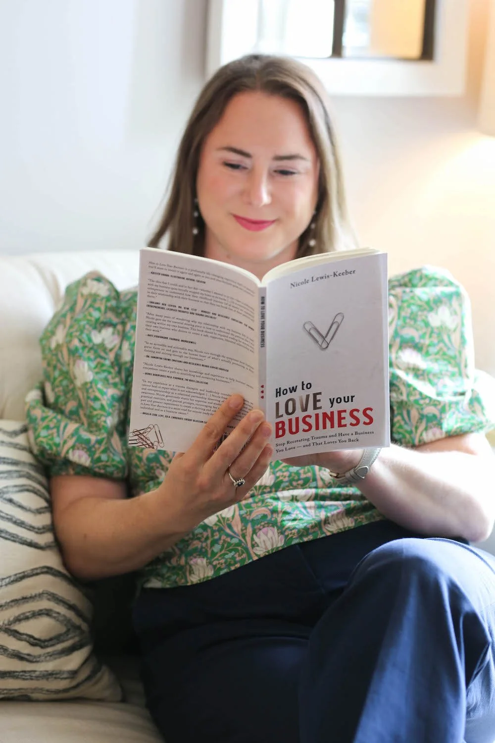 Laura Long reading a book in her office