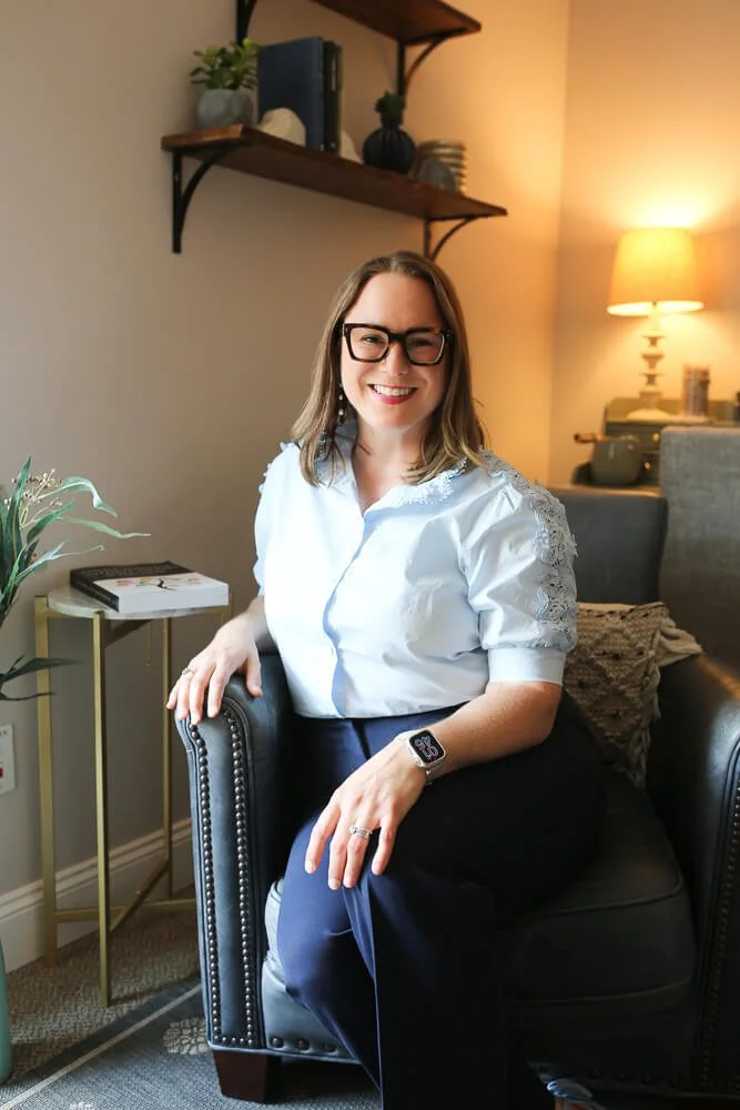 Laura Long sitting in her therapy office