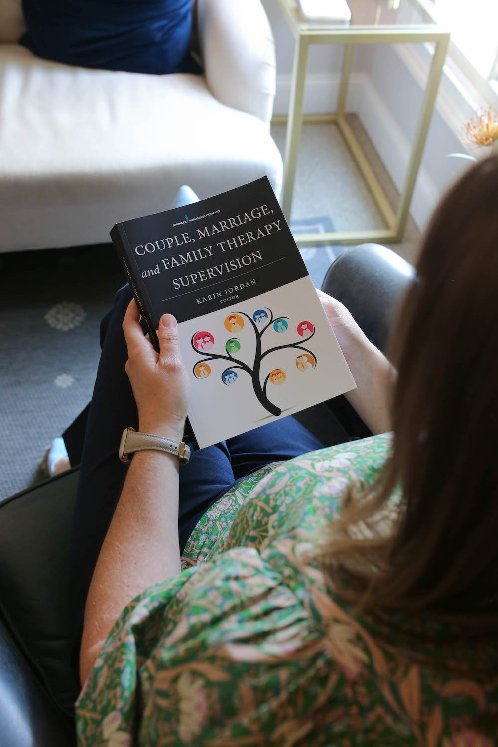 Laura Long holding Couple, Marriage and Family Therapy Supervision book