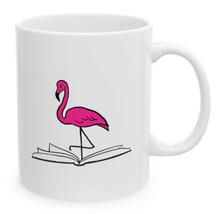 White coffee mug with a pink flamingo standing on an open book print.