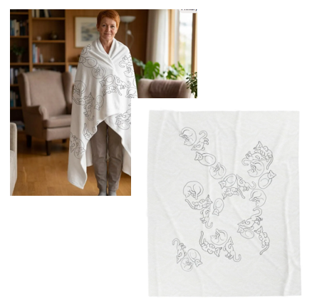 A woman wearing a white shawl with an embroidered floral pattern in a living room with couches, a wooden bookshelf, and a large window with curtains.