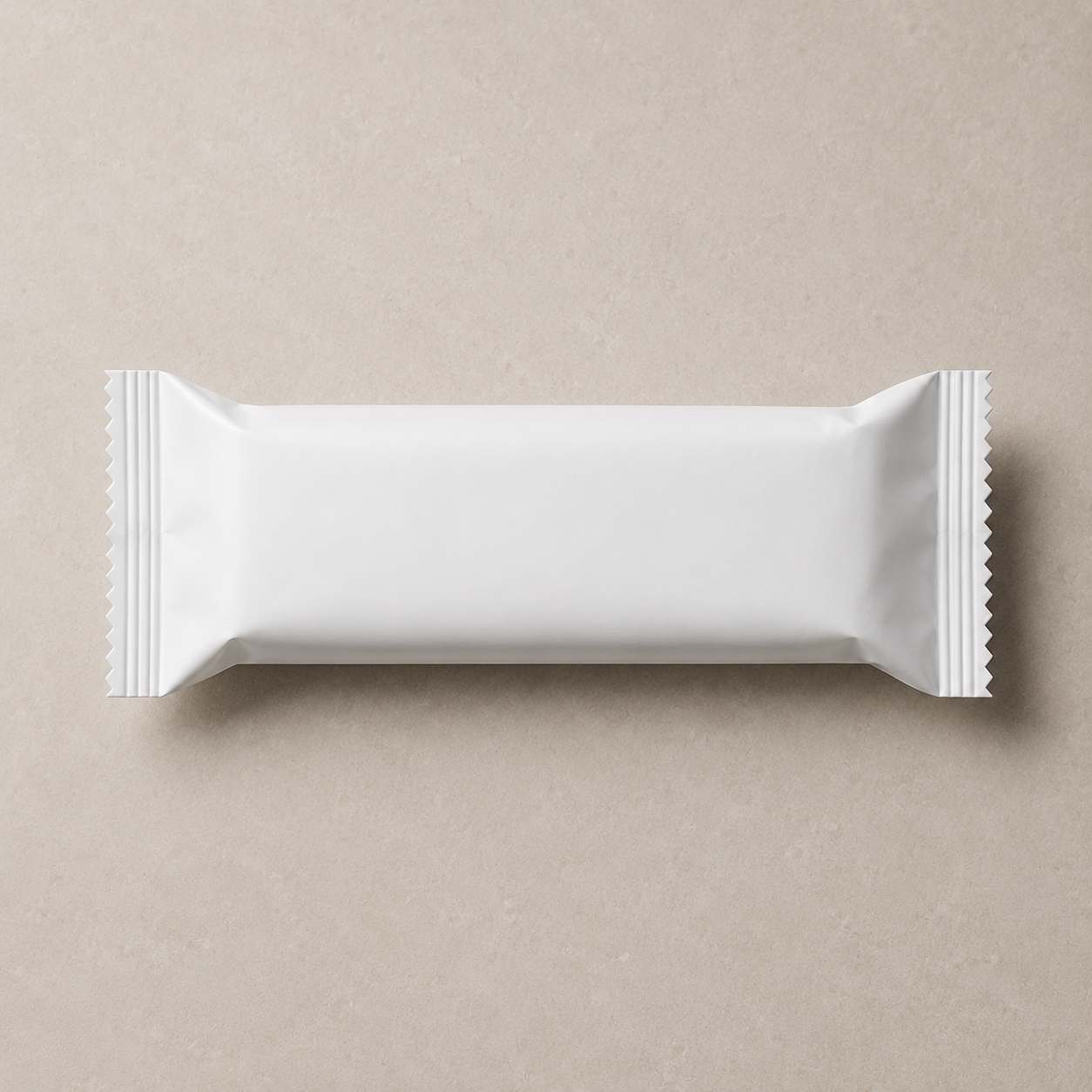 Close-up of a plain white rectangular packaged snack or food item on a beige background.