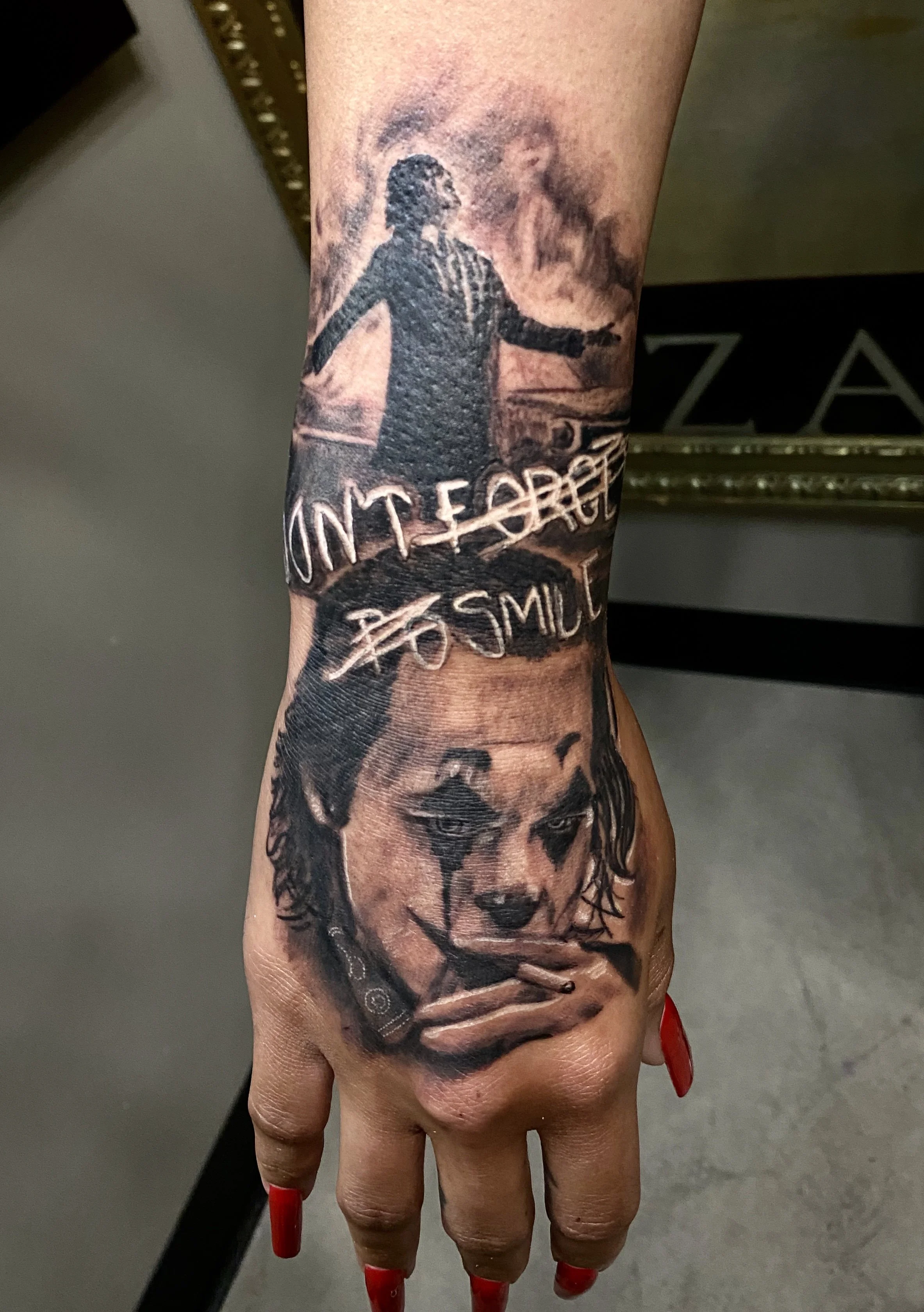 Tattoo of a woman with long hair and a painted face, holding a spear, with handwritten text below that says 'UNTERROR' and 'SMU'.