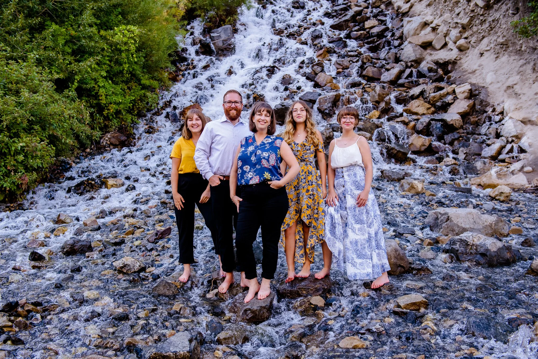 Family portrait standing at Bridal Veil Falls in Provo Canyon