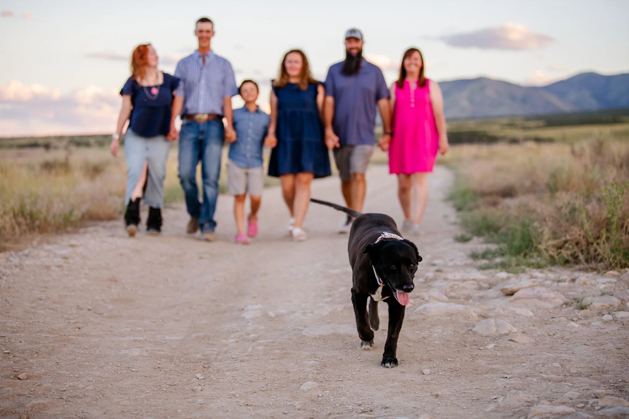 family walking in the west desert with their dog