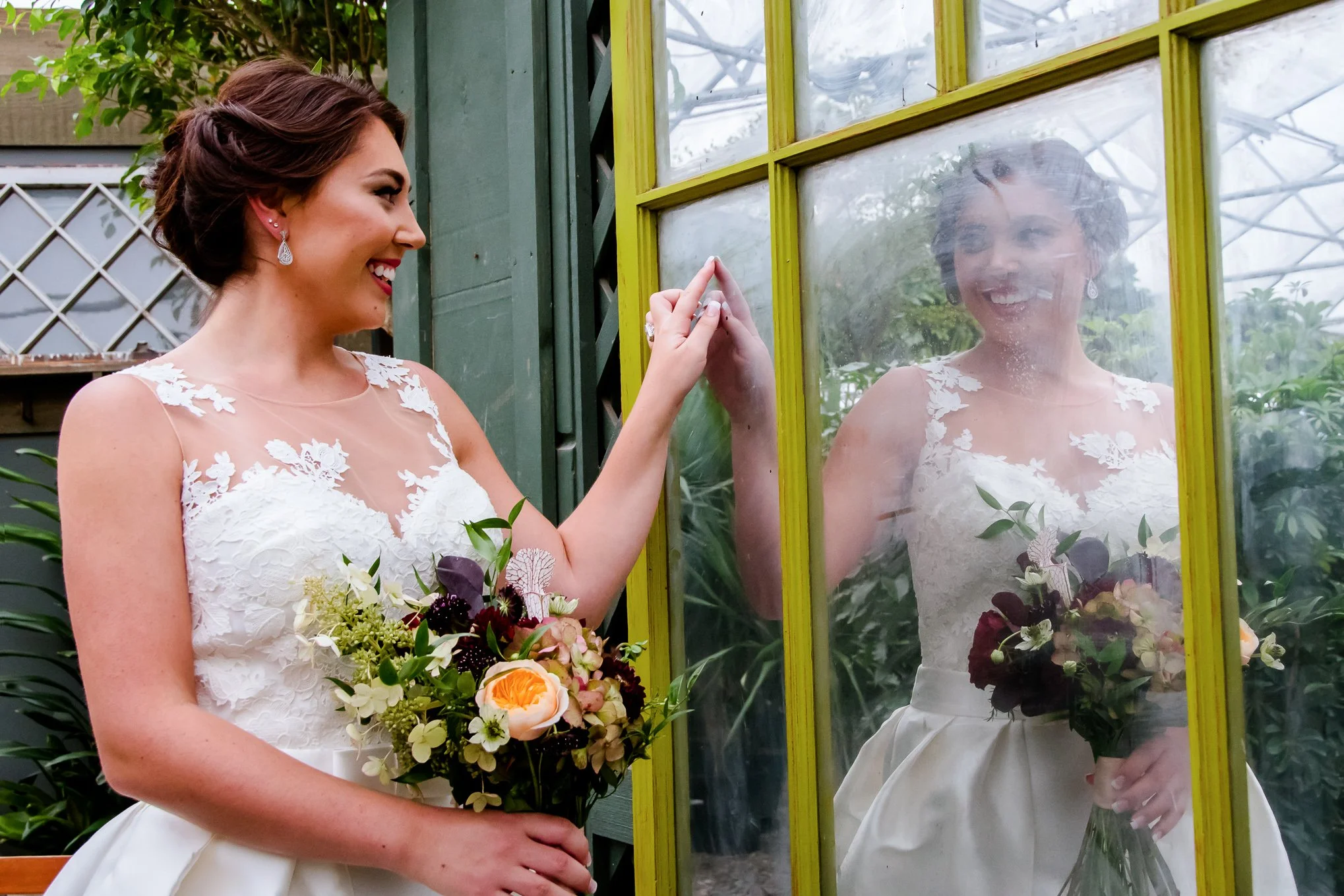 Bride touches her reflection 